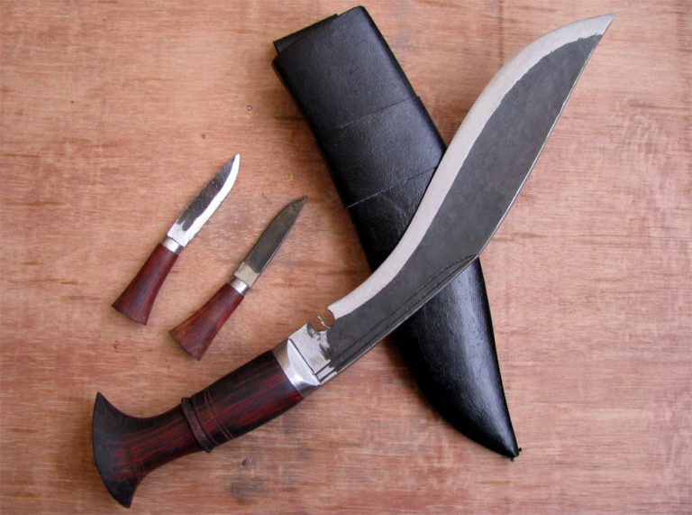 Traditional Nepali khukuri with wooden handles and black sheath, shown with smaller knives.